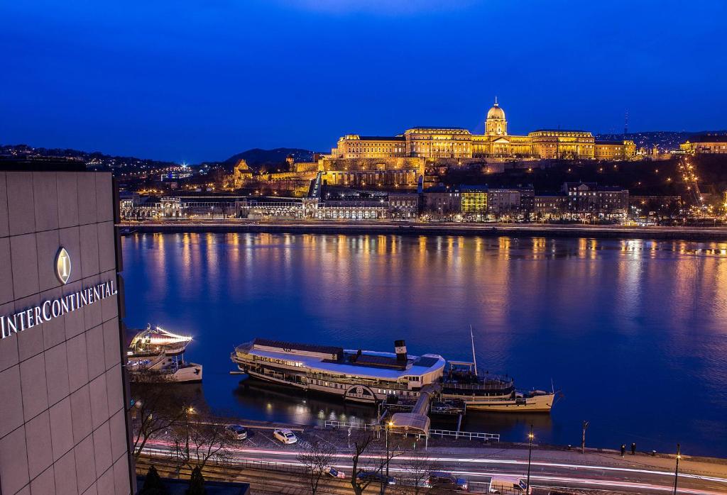 
boats are docked at a pier in front of a city at InterContinental Budapest, an IHG Hotel in Budapest
