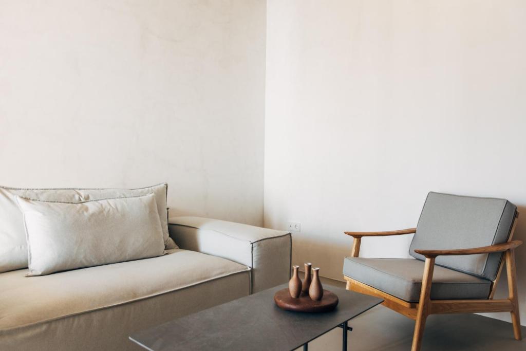 a living room with a couch and a chair at Branco Mykonos in Platis Gialos
