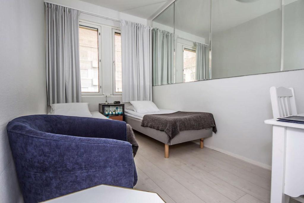 a room with a couch and a bed and a mirror at Best Western Hotel Apollo in Oulu