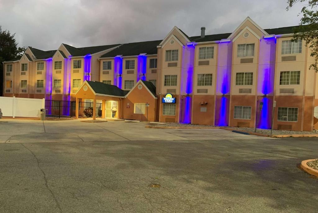 a large building with purple lights on it at Days Inn & Suites by Wyndham Tampa/Raymond James Stadium in Tampa