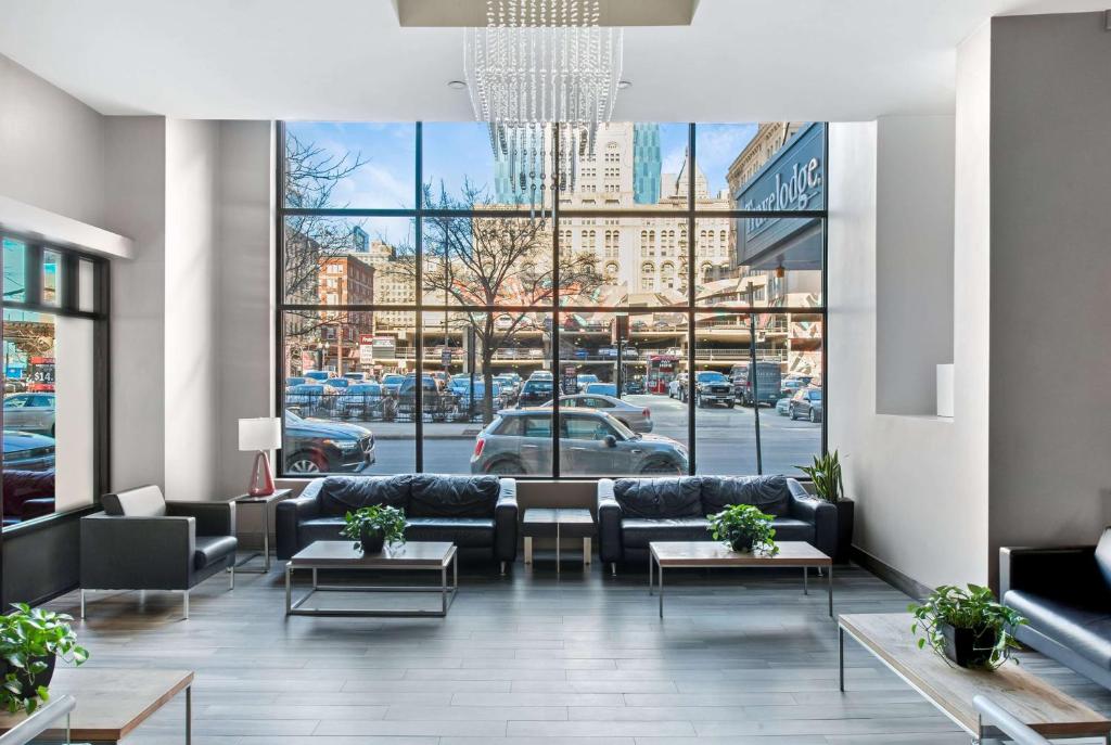 a lobby with couches and tables and a large window at Travelodge by Wyndham Downtown Chicago in Chicago