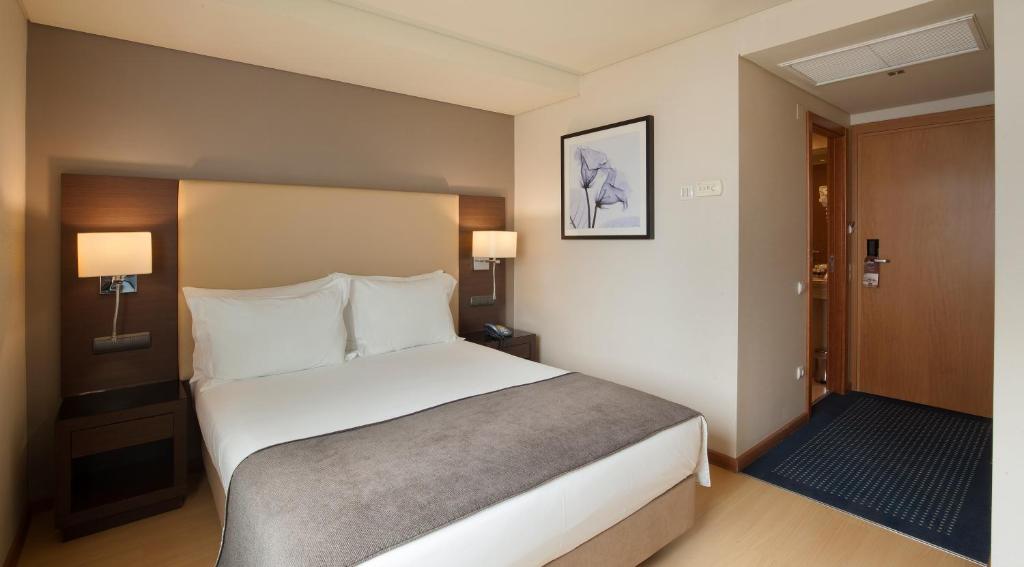 a bedroom with a large bed in a hotel room at TURIM Ibéria Hotel in Lisbon