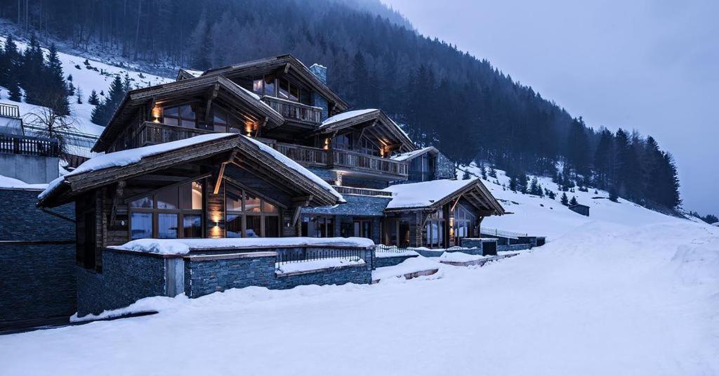 a large log cabin in the snow with snow at ON Chalet Residences Mathon-Ischgl in Mathon