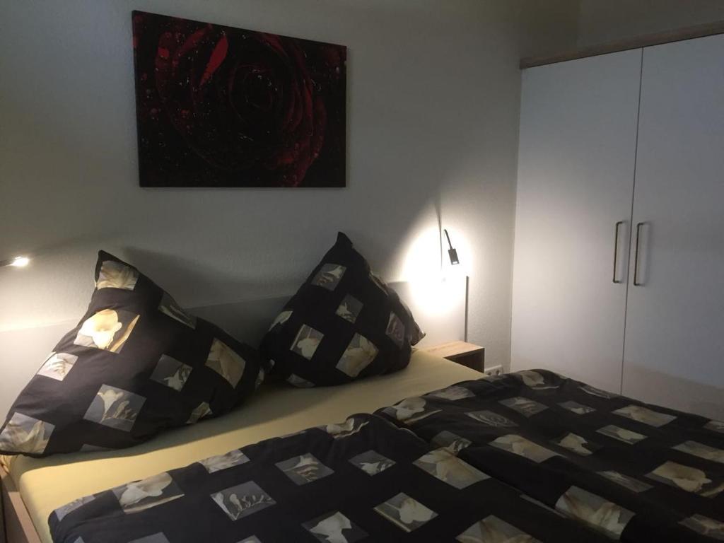 a bedroom with a bed with black and white pillows at Residenz Bollwark Port Olpenitz in Kappeln