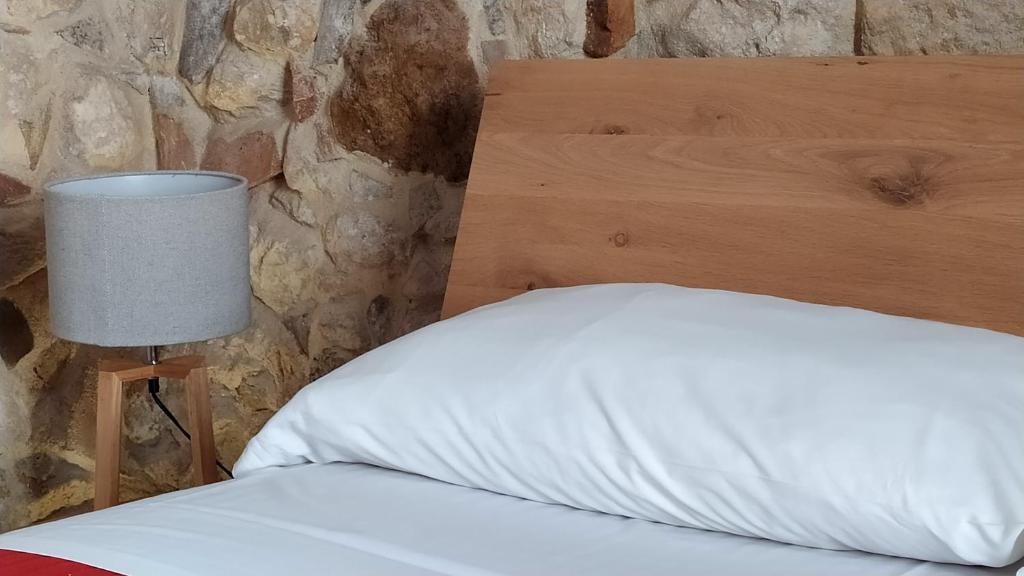 Postel nebo postele na pokoji v ubytování Chiusa Di Carlo Agriturismo