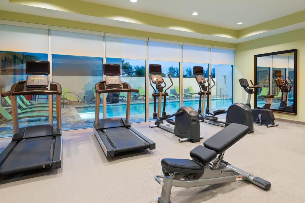 a gym with several treadmills and elliptical machines at Staybridge Suites - Miami International Airport by IHG in Miami