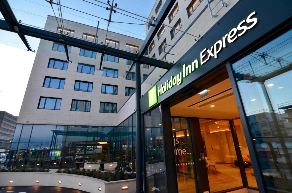 a building with a sign in front of it at Holiday Inn Express - Paris - CDG Airport by IHG in Roissy-en-France