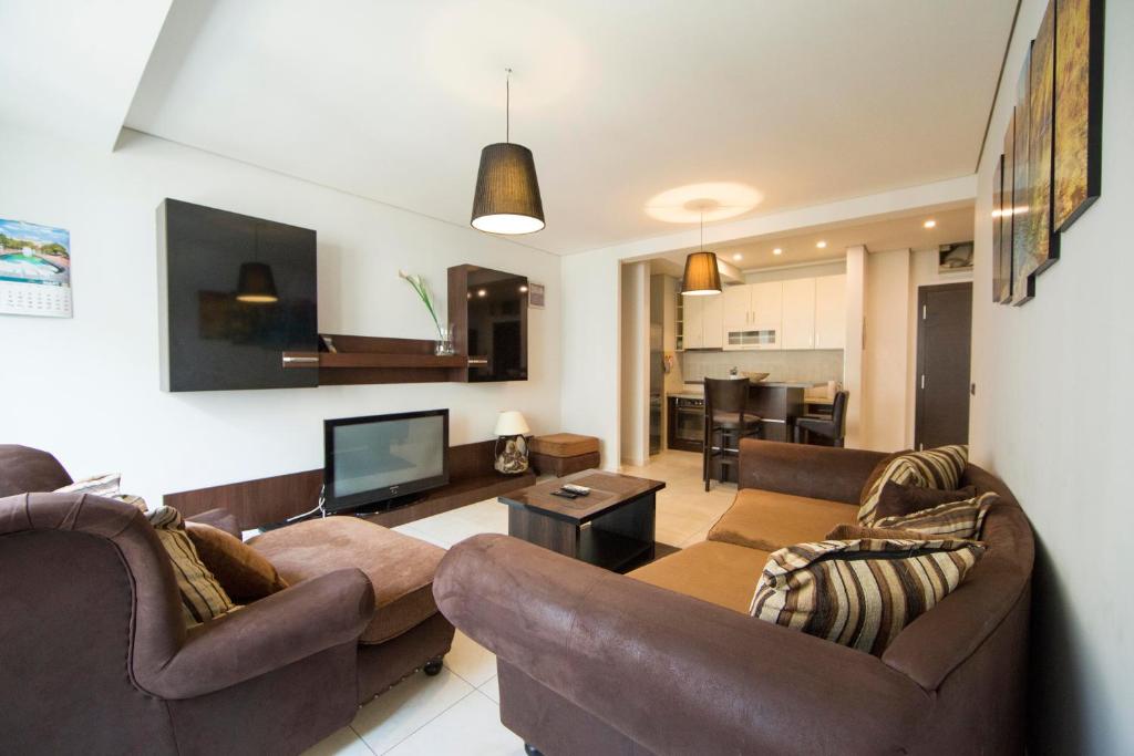 a living room with two couches and a television at Ahoy Luxury Apartment in Belgrade