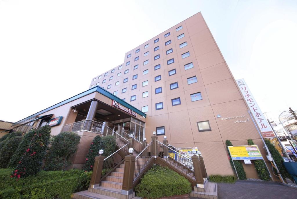 a building with a staircase in front of it at Richmond Hotel Tokyo Musashino in Musashino