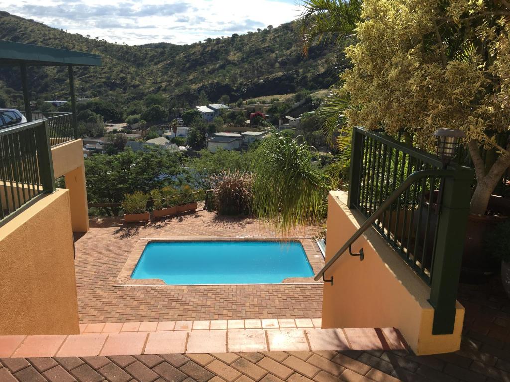 a swimming pool with a view of the mountains at Felsenblick Self-Catering in Windhoek