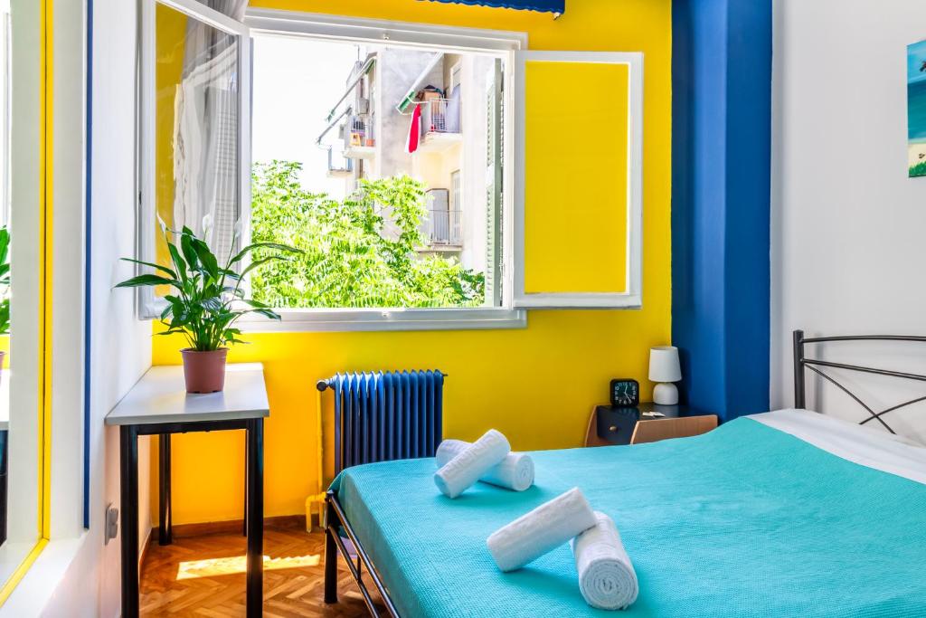 um quarto com uma cama azul e uma janela em Travel Resort em Atenas