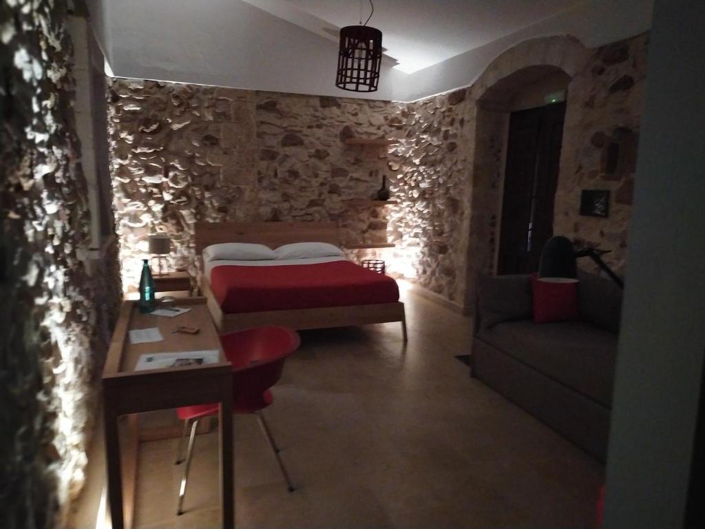 Postel nebo postele na pokoji v ubytování Chiusa Di Carlo Agriturismo