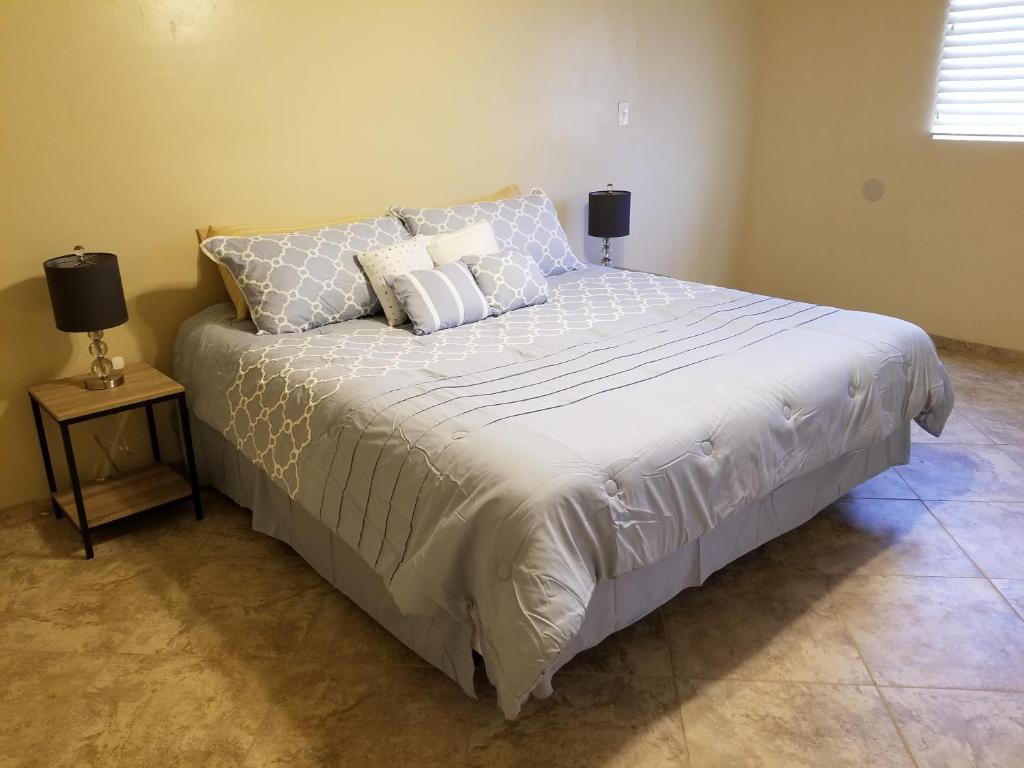 a bedroom with a large bed with pillows on it at Tucson Airport Oasis in Tucson