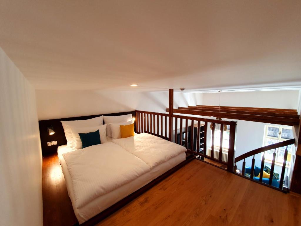 a bedroom with a bed on a balcony at Hotel KORTUS in Jetřichovice