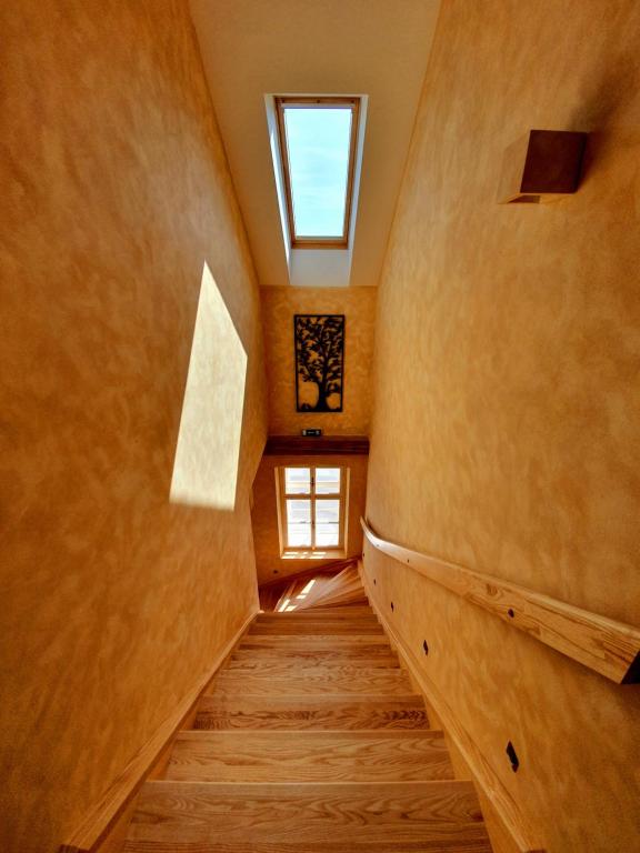 a staircase in a house with a window at Hotel KORTUS in Jetřichovice
