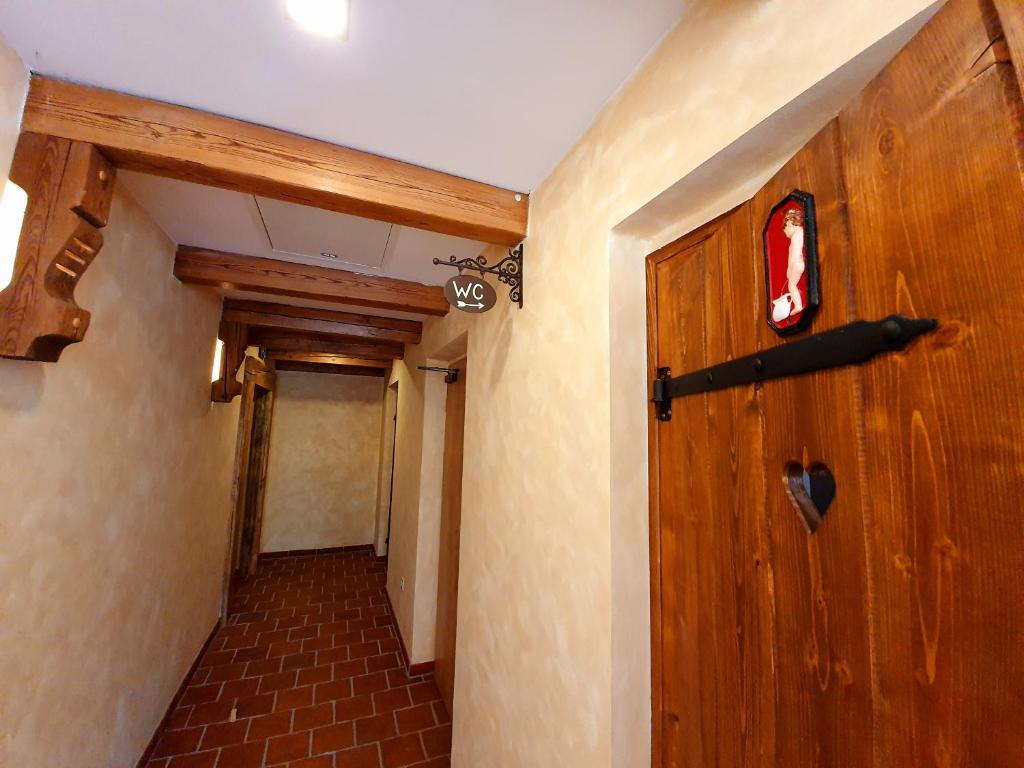 a hallway with a wooden door in a room at Hotel KORTUS in Jetřichovice