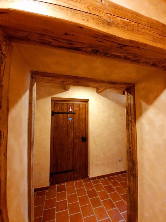 a hallway with a wooden door in a room at Hotel KORTUS in Jetřichovice