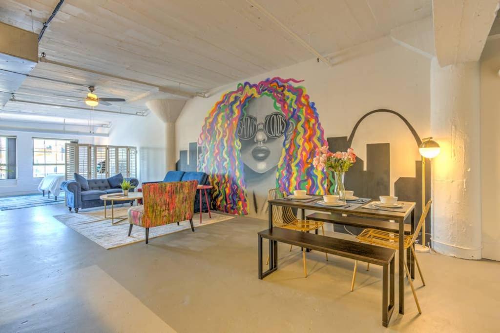 a living room with a rainbow mural on the wall at Vogue loft walk to CityMu/Cards/Aquarium/ConvCtr in Saint Louis