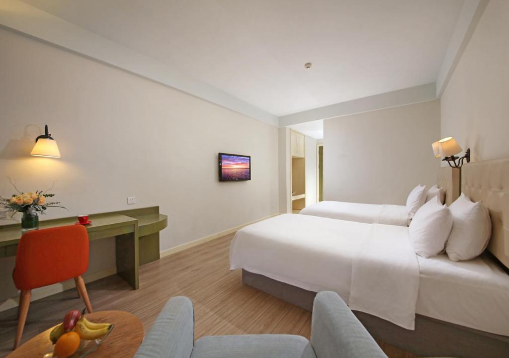 Postel nebo postele na pokoji v ubytování City Hotel Xiamen-Free Welcome Fruits