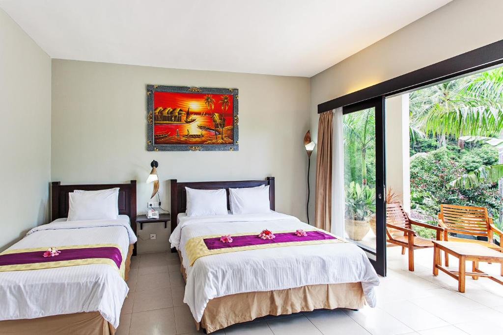 Una cama o camas en una habitación de Kebun Villas & Resort