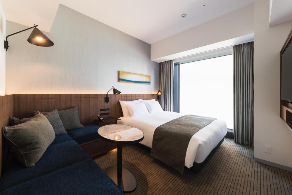 Postel nebo postele na pokoji v ubytování Hotel Metropolitan Kawasaki