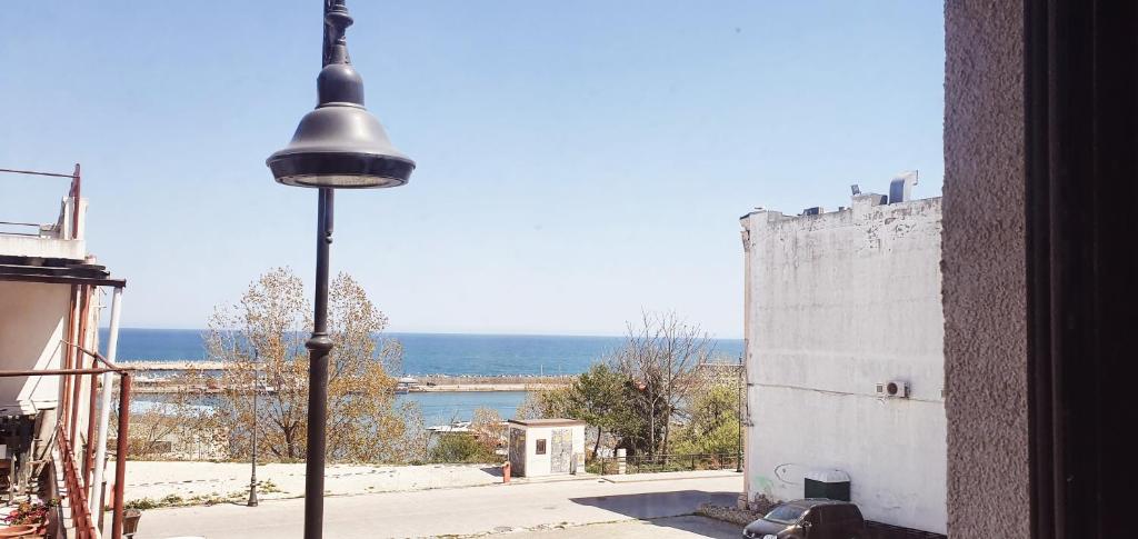 a street light next to a building with a view of the ocean at ZIG ZAG Apartment 8- Old Town in Constanţa