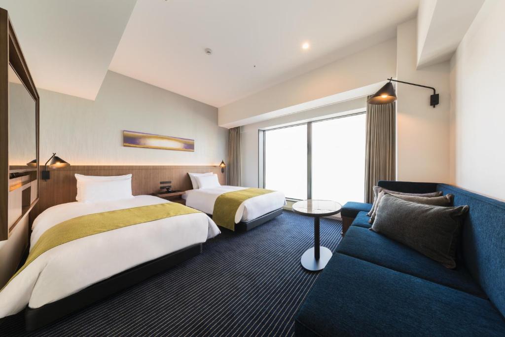 Postel nebo postele na pokoji v ubytování Hotel Metropolitan Kawasaki