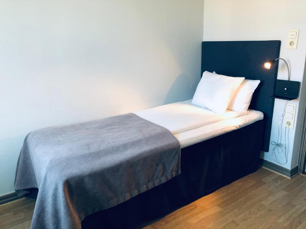 Postel nebo postele na pokoji v ubytování Grand Hotel Falkenberg