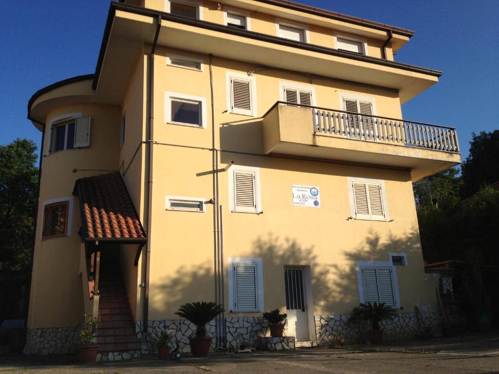 a large yellow building with a balcony on it at La Rosa Blu Rende in Rende