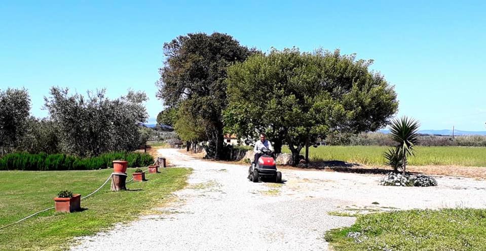 a person riding a moped down a dirt road at Agriturismo Ristorante Monte Argentario in Monte Argentario