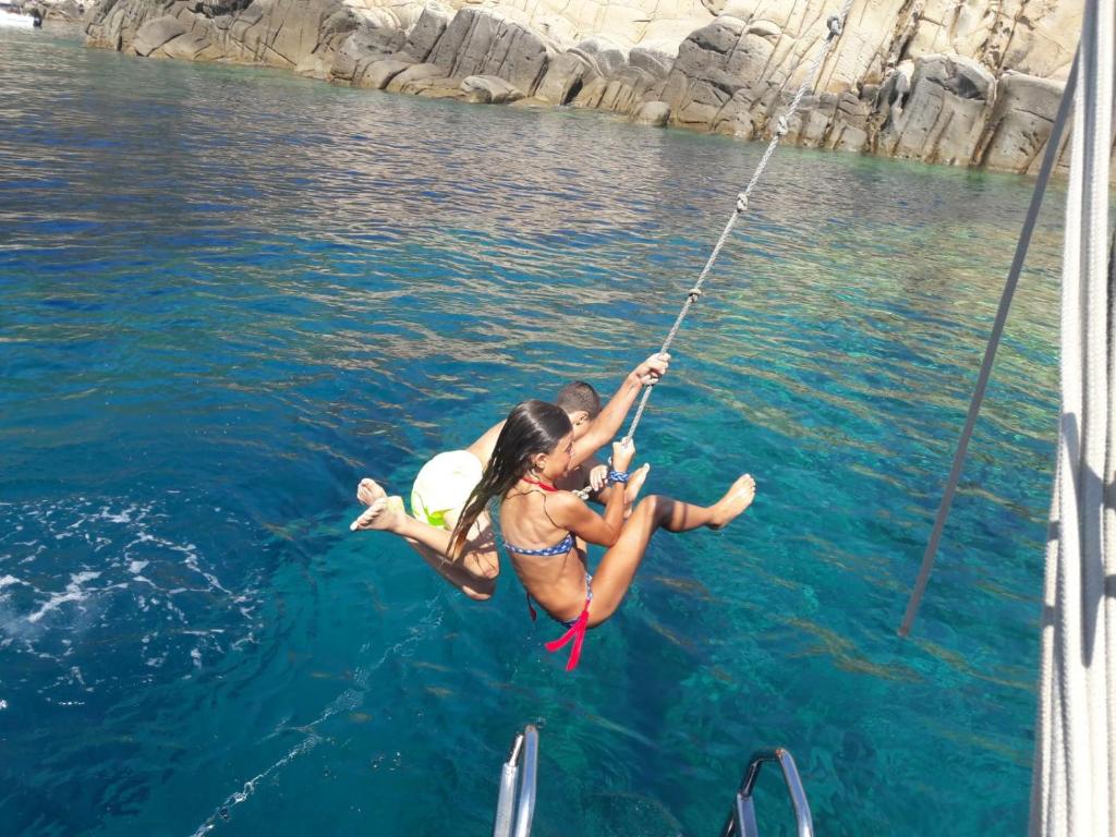 two people on a boat in the water at Bike&Boat Argentario Hotel in Porto Santo Stefano