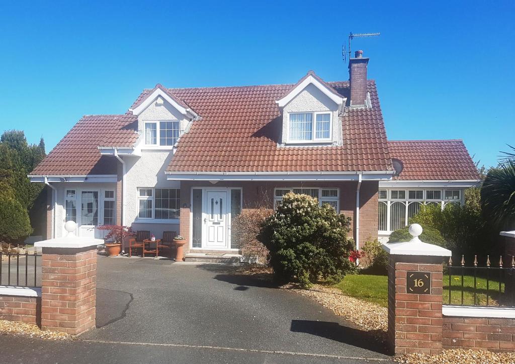 a house with a red roof and a driveway at Highfields Self Contained Studio in Newry