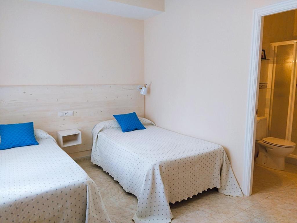 Posteľ alebo postele v izbe v ubytovaní Apartamentos Rodeiramar 2A