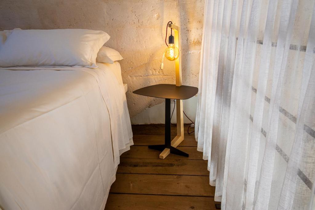 Ein Bett oder Betten in einem Zimmer der Unterkunft L'Artiere Dimore nei Sassi