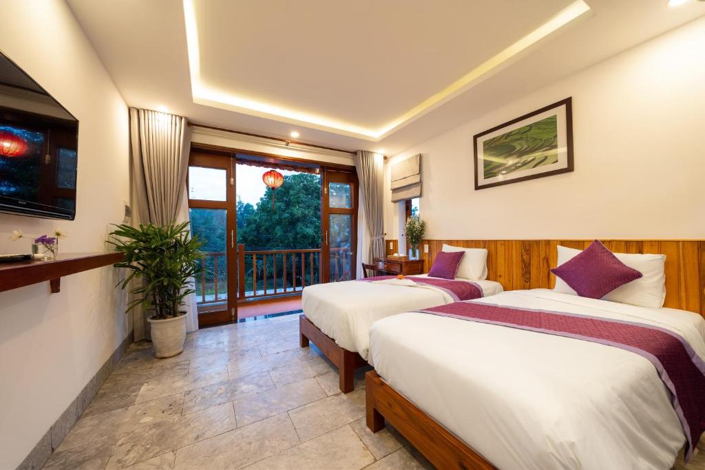 Rúm í herbergi á Lama Beach Villa