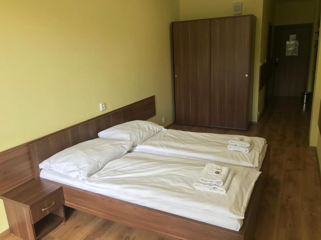 Postel nebo postele na pokoji v ubytování Hotel Aréna