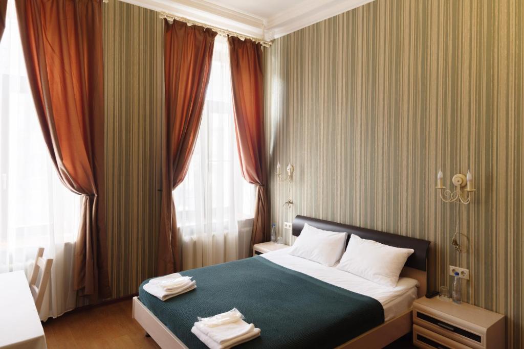 a hotel room with a bed and a window at Inn 6 Line in Saint Petersburg