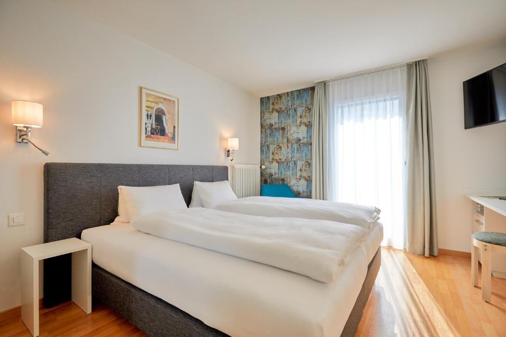 Postel nebo postele na pokoji v ubytování Hotel Schmid & Alfa