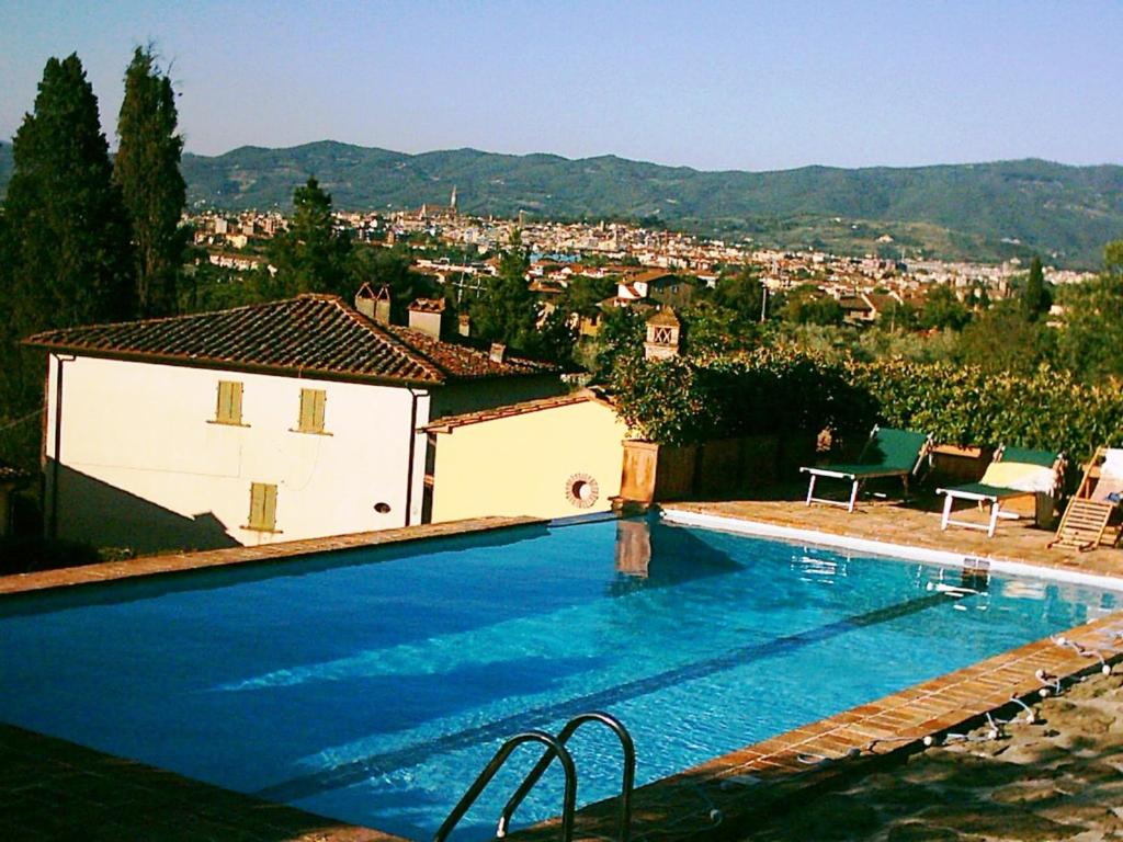 a large swimming pool in front of a house at Casa Limonaia in Arezzo