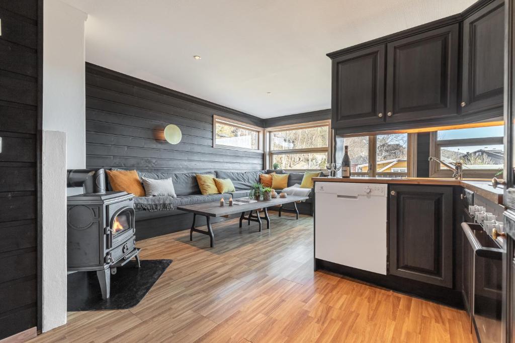 a kitchen and living room with a couch and a stove at Skiers Lodge 2 - Saga Apartments in Hemsedal
