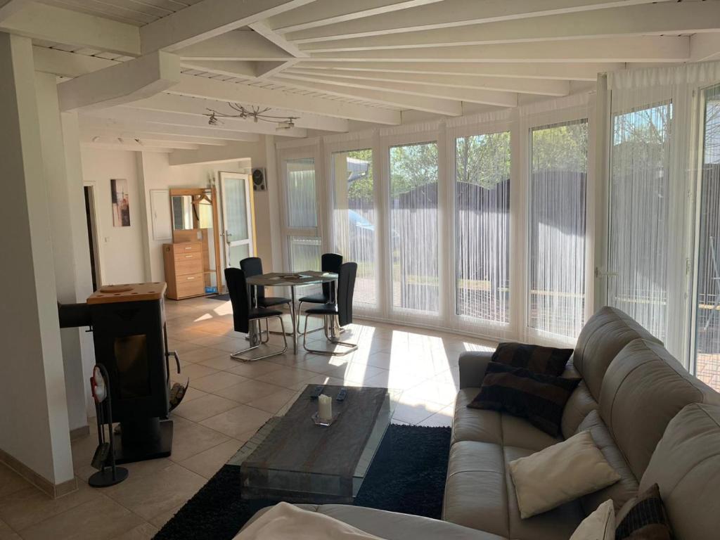 a living room with a couch and a table at Bungalow in Werder am Glindower See in Werder