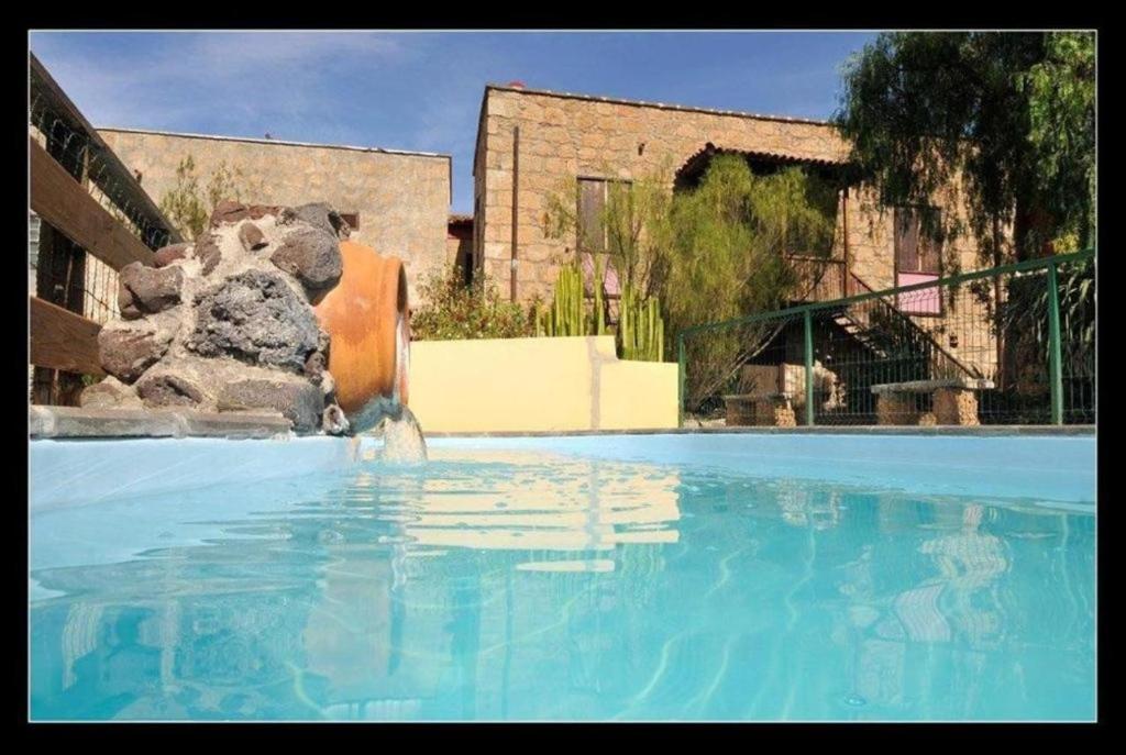 a large pool of blue water in a building at Casa Rural La Venta in Granadilla de Abona