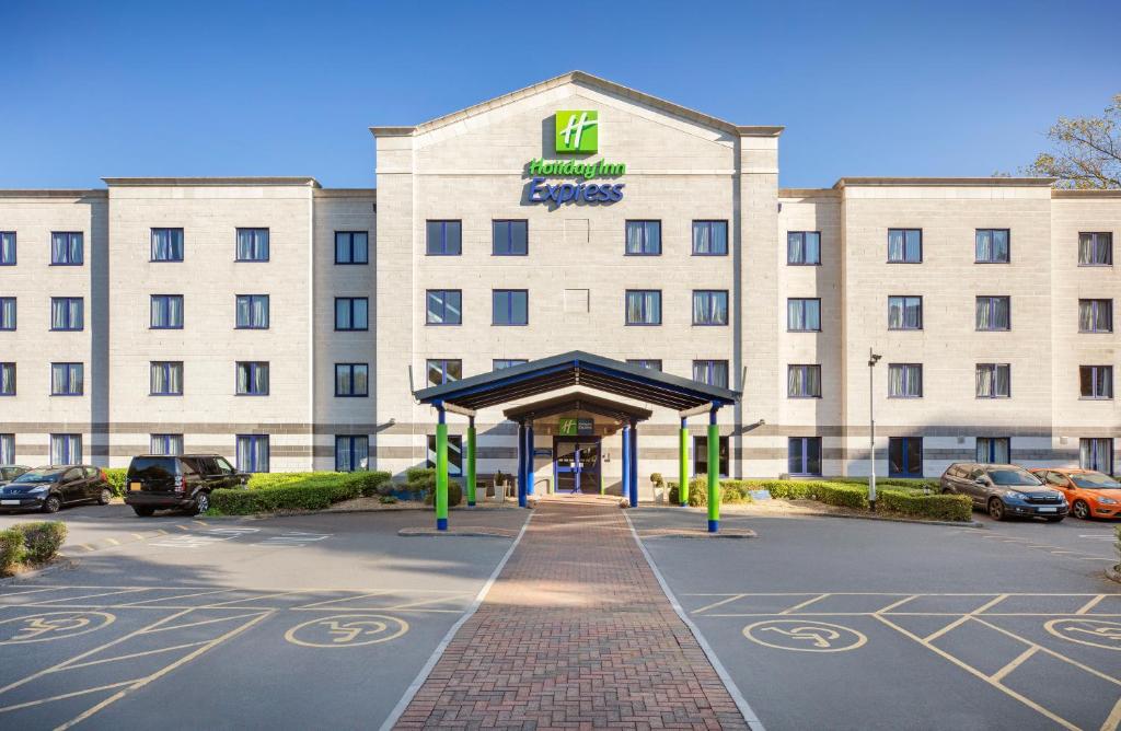 a large building with a large sign on the side of it at Holiday Inn Express Poole, an IHG Hotel in Poole