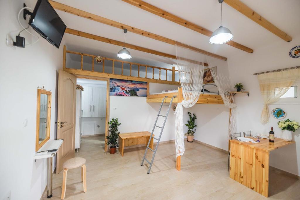 a room with a loft bed and a desk at Manolis Studio in Kolimbia