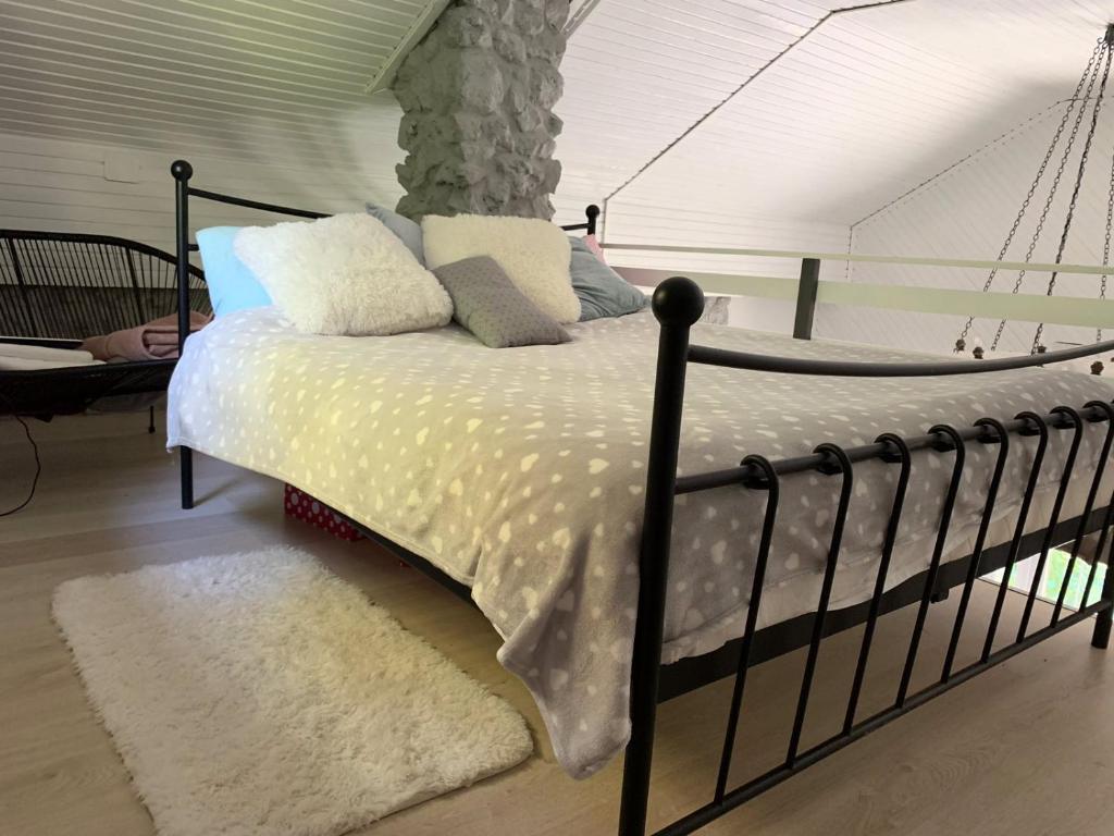 a bedroom with a bed with a white comforter at Agape Glamping in Velika Remeta