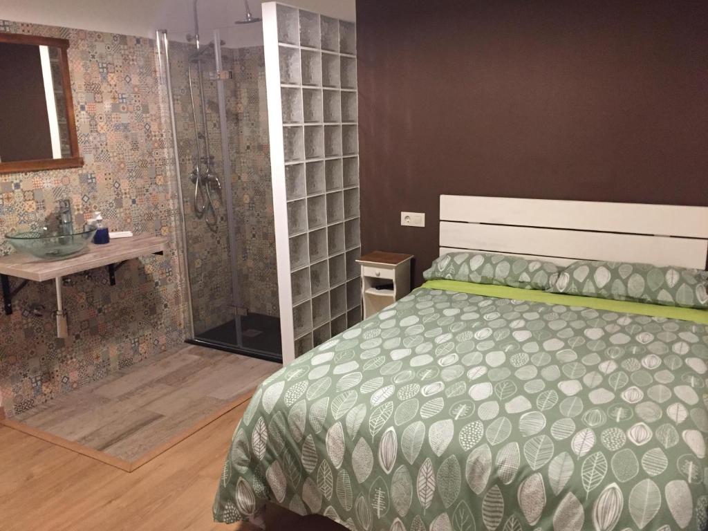 1 dormitorio con cama grande y ducha en HOSTEL LA CABAÑUELA, en Monleras
