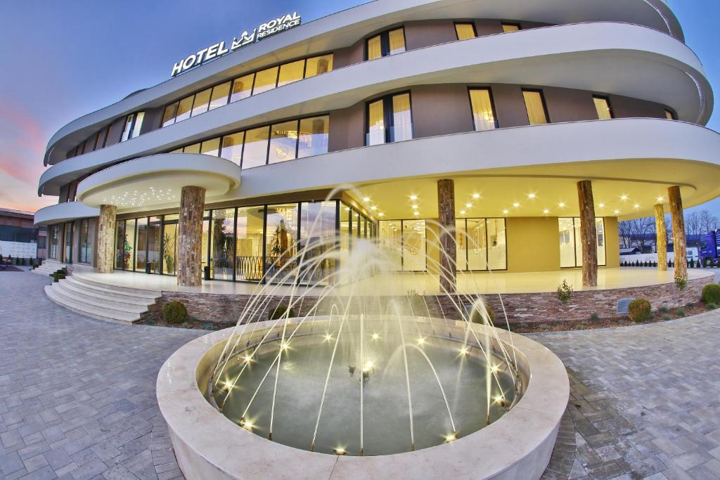 a building with a fountain in front of it at Royal Residence in Čačak