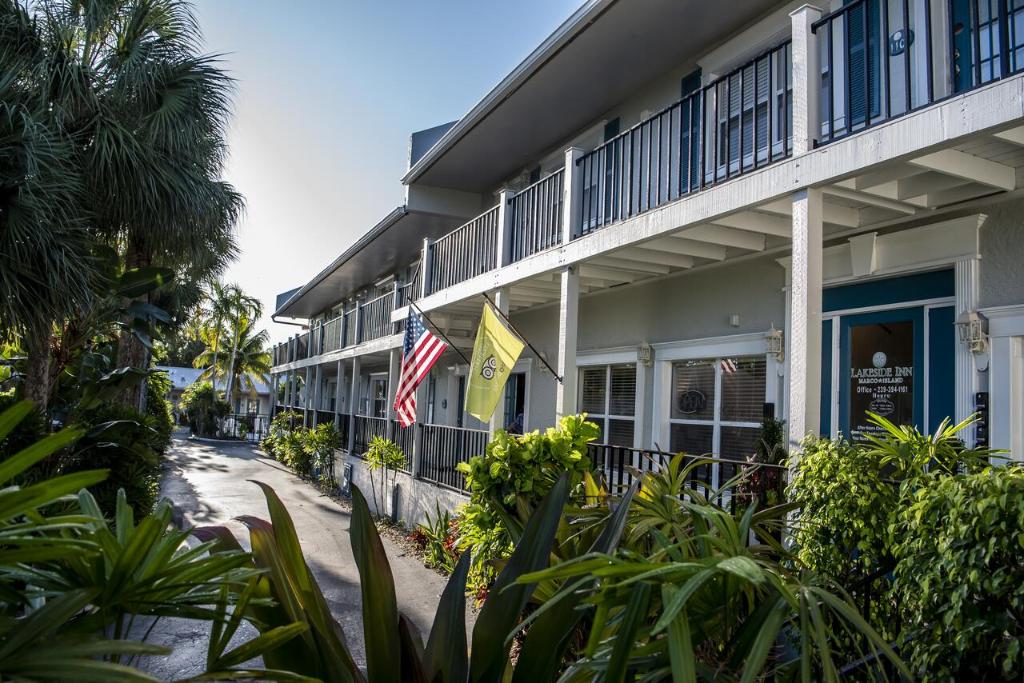 a side view of a building with flags and plants at Marco Island Lakeside Inn in Marco Island