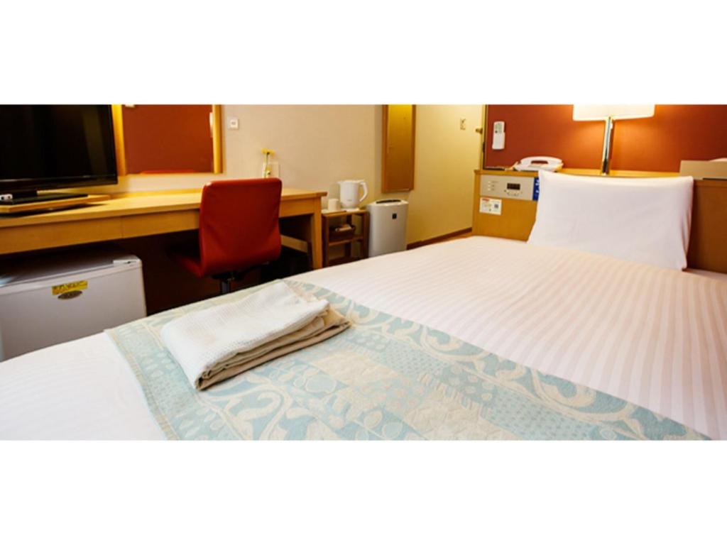 Ένα ή περισσότερα κρεβάτια σε δωμάτιο στο Hakata Floral Inn Nakasu / Vacation STAY 80206