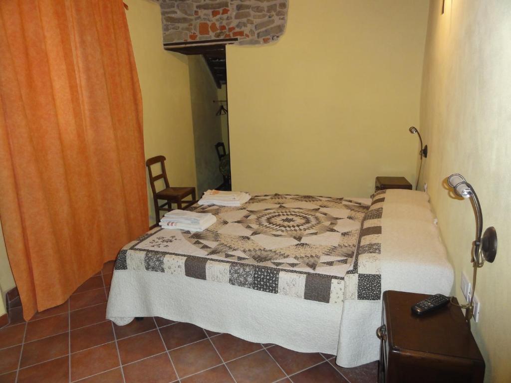 A bed or beds in a room at La Locanda Dei Cartunè